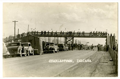 postcard showing Indiana Ordnance Works employees walking on a walk bridge over Highway 62 in Charlestown, Indiana