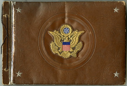 a brown scrapbook with a gold eagle Army emblem on the front